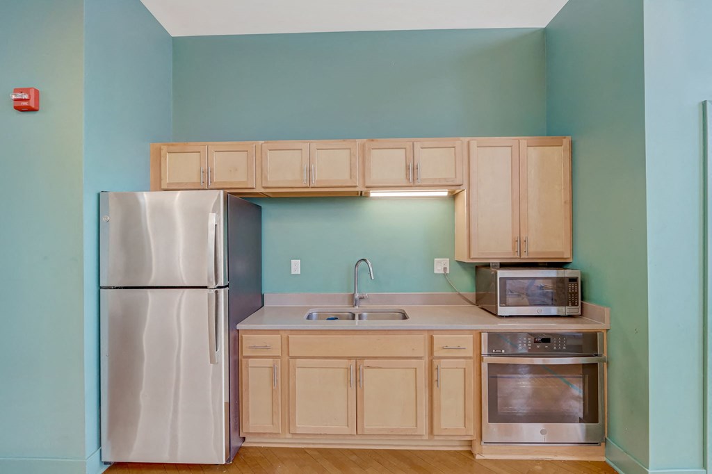 a small kitchen with a refrigerator and a sink