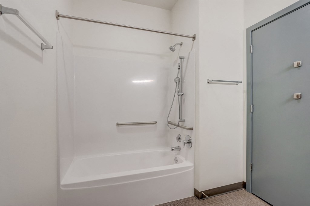a white bathroom with a shower and a tub