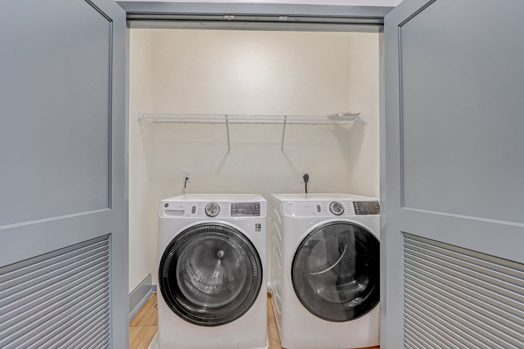 a washer and dryer in a laundry room with a closet