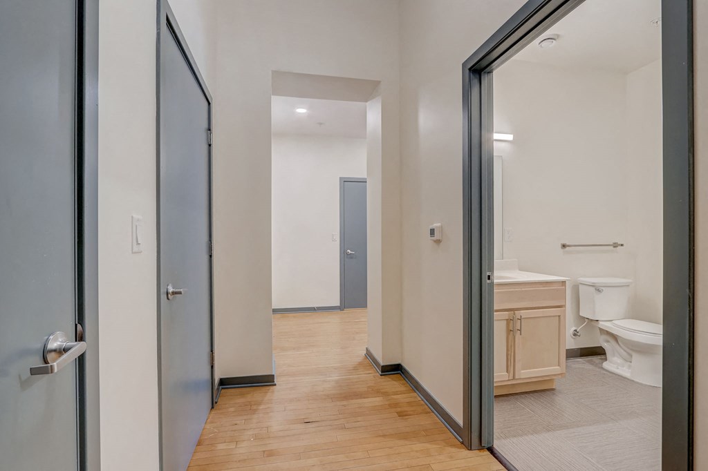 a bathroom with a toilet and a glass door