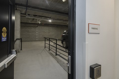 A parking sign is on the wall next to a door.