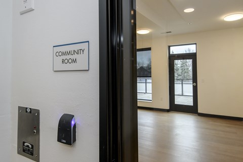 A community room is entered by pushing a button on a wall.