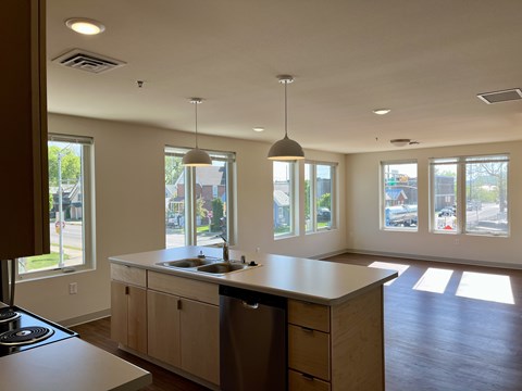 A kitchen with a large island and a stove top oven.