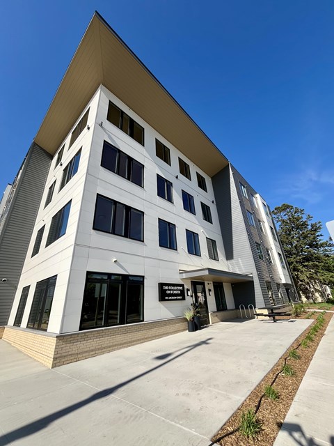 A modern building with a white facade and a yellow roof.