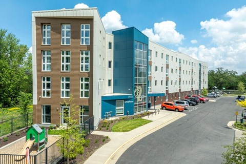A modern building with a playground in front.