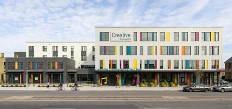 A white building with the words "Creative Cowork" on the side.