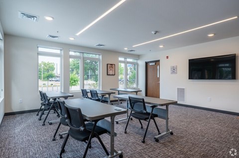 A conference room with a long table and chairs.