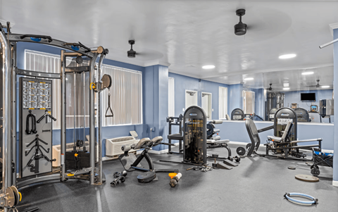 A gym with a variety of exercise equipment.