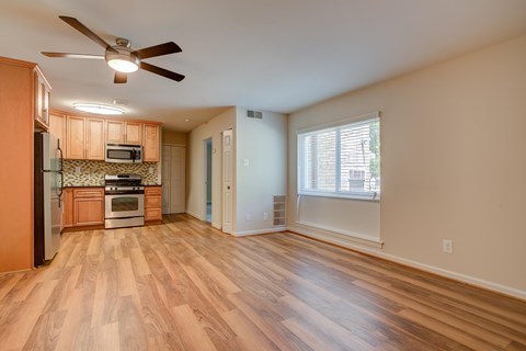 A kitchen with wooden floors and a ceiling fan at Potomac Ridge Apartments, Woodbridge, Virginia