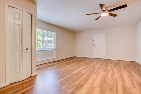 A room with a ceiling fan and wooden flooring at Potomac Ridge Apartments, Woodbridge, VA