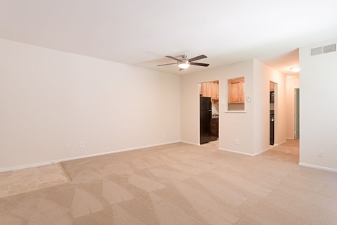 A room with a ceiling fan and a door leading to another room at Potomac Ridge Apartments, Virginia