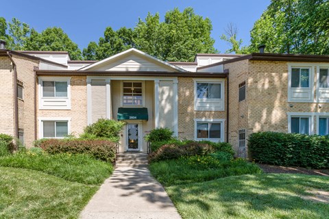 A building with a green awning and a white door at Potomac Ridge Apartments, Virginia, 22191