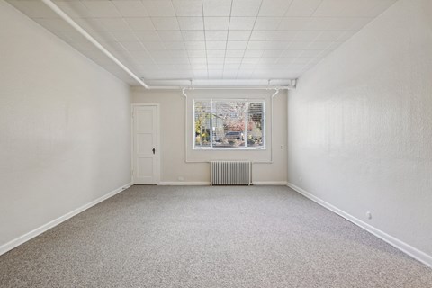 A room with a window and a door.