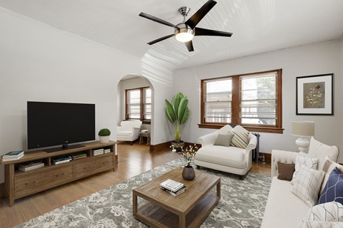a living room with a white couch and a tv