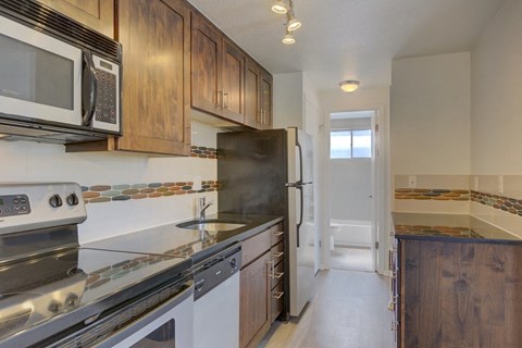 a kitchen with stainless steel appliances and wooden cabinets