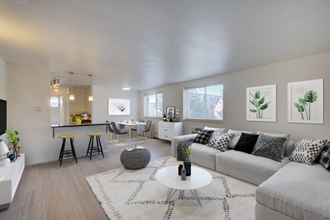 the living room of an apartment with a couch and a table