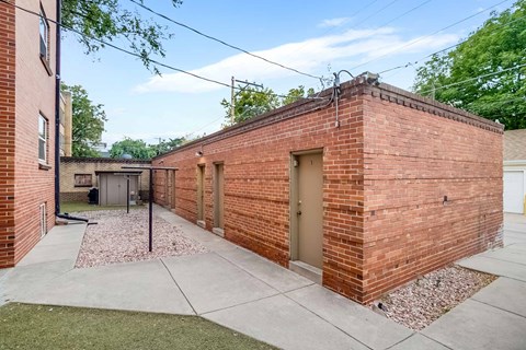 A brick building with a door and windows.