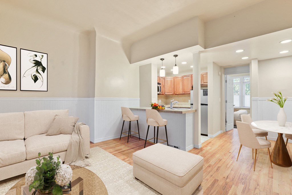 a living room and kitchen with a couch and a table