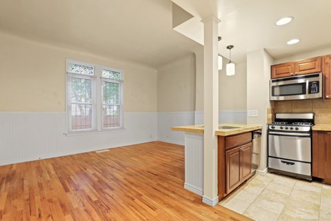 an empty kitchen with an island and a stove and a microwave