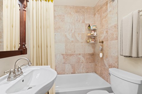 a small bathroom with a sink toilet and shower