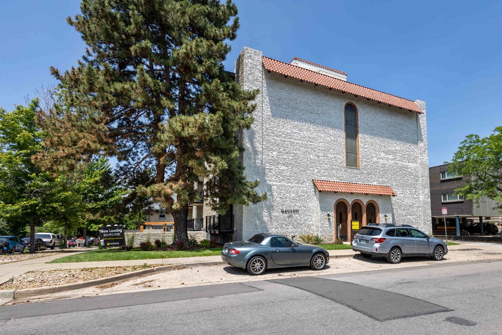 a church with two cars parked in front of it