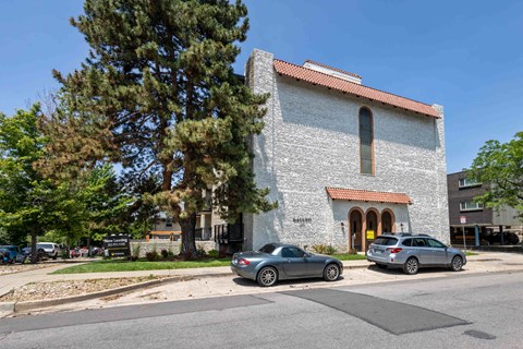 a church with two cars parked in front of it