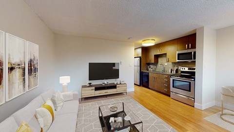 A modern living room with a white sofa and a television.