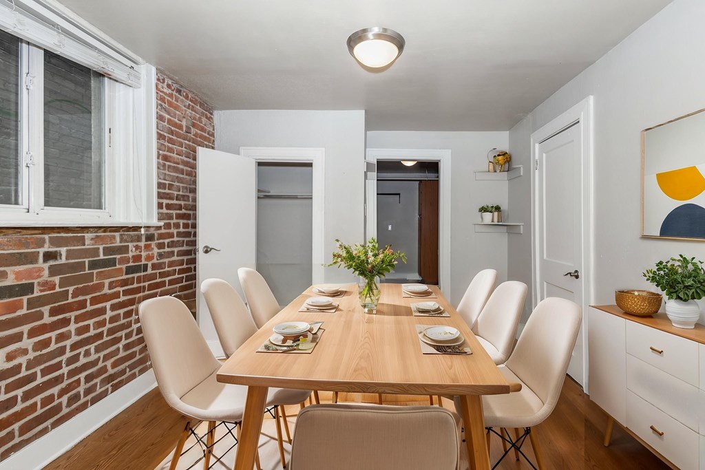 A dining room with a long table and chairs.