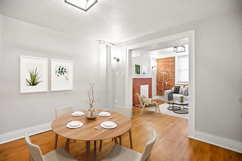 a dining room and living room with a table and chairs