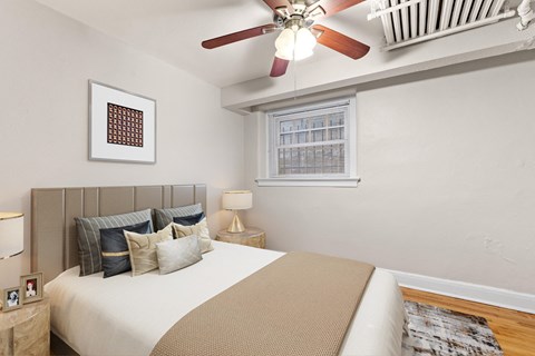 a bedroom with a bed and a ceiling fan