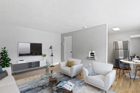 a living room with white furniture and a tv