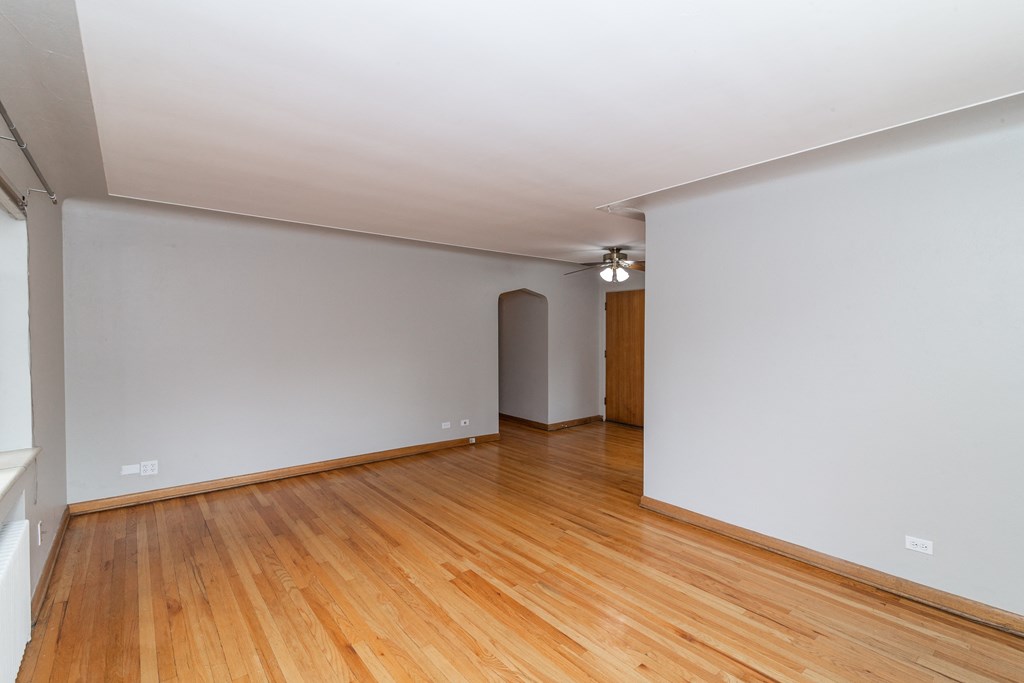 A room with wooden floors and white walls.
