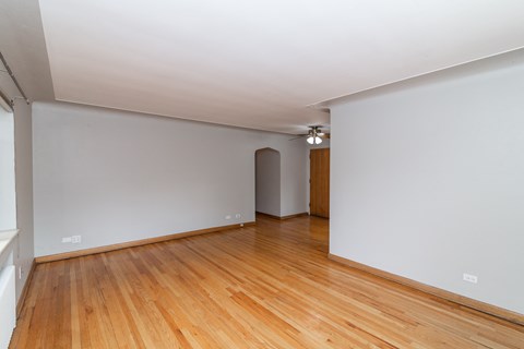 A room with wooden floors and white walls.