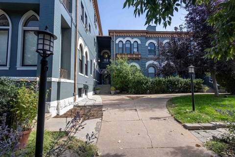 a sidewalk in front of a row of houses