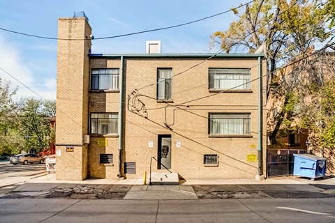 A brick building with a large mural on the side.