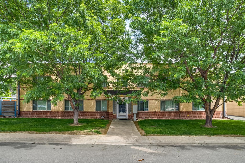 A building with a tree in front of it.