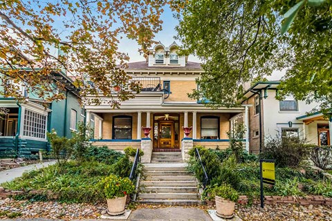 A house with a front porch and steps leading up to the door.
