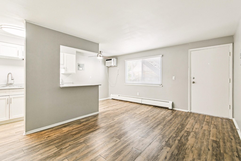 A room with wooden floors and white walls.
