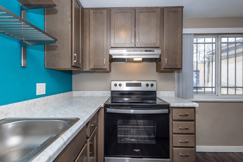 A kitchen with a stove and sink.