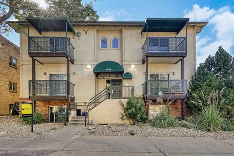 A two-story building with a balcony on the second floor.