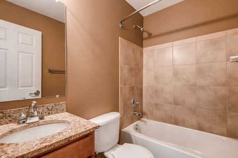 A bathroom with a sink, toilet, and bathtub.