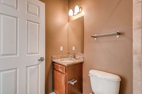 A white toilet sits next to a sink in a bathroom.
