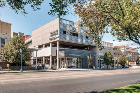A modern building with a glass facade and a sign that reads "The American".