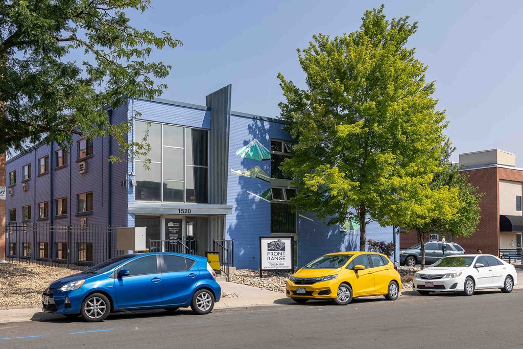 a blue building with cars parked in front of it