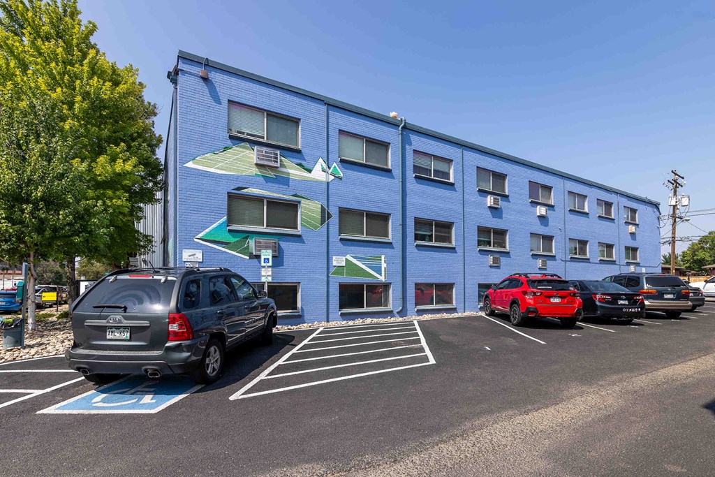 a blue building with cars parked in front of it