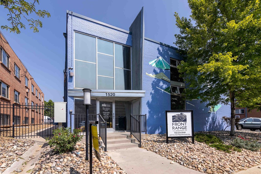 a blue building with a sign in front of it