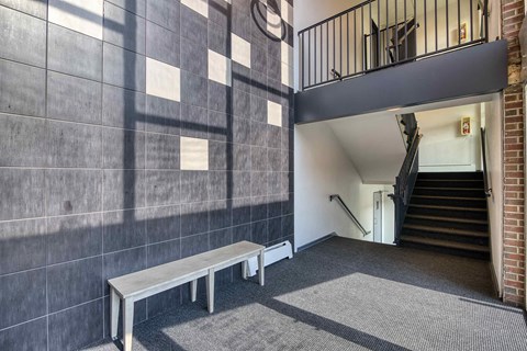 a bench in front of a building with stairs
