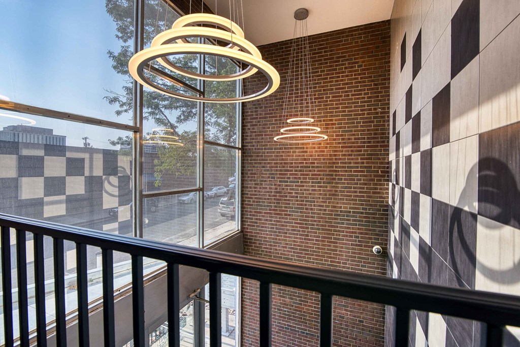 a balcony with a view of a brick wall and a window