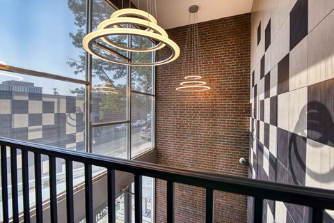 a balcony with a view of a brick wall and a window
