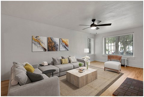 a living room with a couch and a ceiling fan